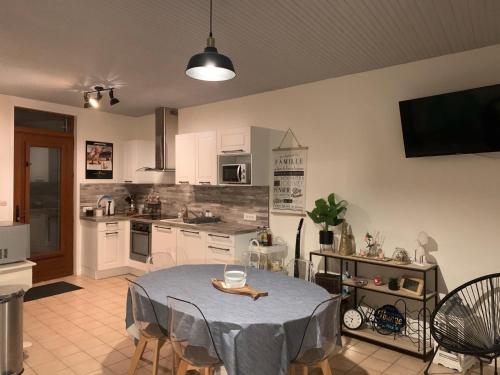 une cuisine avec une table et un chiffon bleu dans l'établissement La Parenthèse - maison Tréportaise avec cour fermée, au Tréport