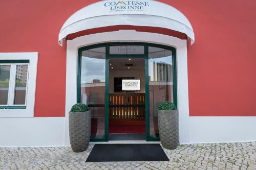 a red building with a door to a library at Comtesse Lisbonne Guest House by Homing in Lisbon