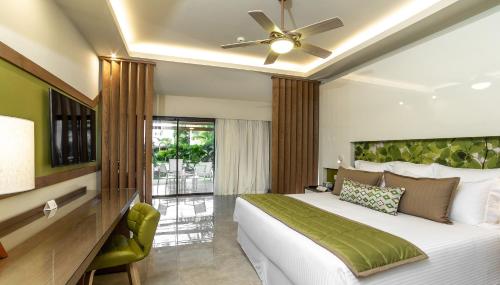 a bedroom with a large bed and a ceiling fan at Dreams Onyx Resort & Spa - All Inclusive in Punta Cana