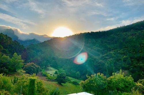 a view of the sun setting over a valley at Casa Tatisita Buhardilla in Segura de la Sierra