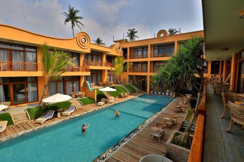 
a large swimming pool in a residential area at Thaproban Pavilion Resort and Spa - Level 1 Certified in Unawatuna
