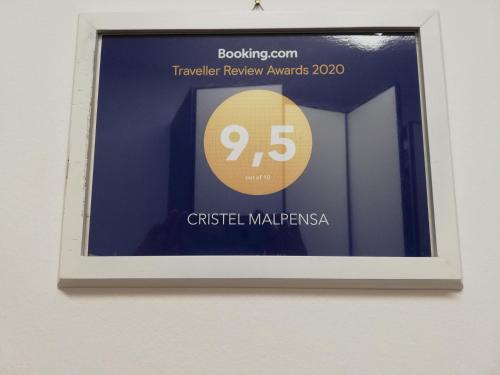 a framed picture of a sign on a wall at Cristel Malpensa apartment in Cardano al Campo