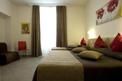 A bed or beds in a room at Ara Pacis Inn