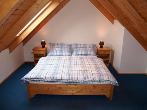 a bedroom with a bed with two night stands at Penzion Vital in Liberec