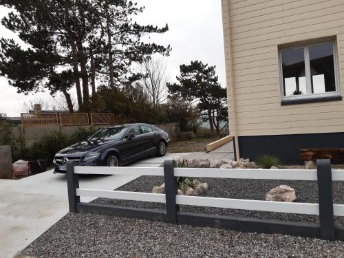 a car parked in a driveway next to a house at Le Panorama - Vue mer in Criel-sur-Mer