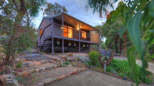 a house with a wooden floor and a large window at 31 The Rocks in Stanthorpe