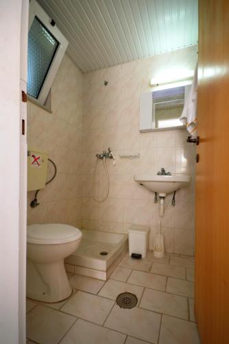a bathroom with a toilet and a sink at Studio Anthoula in Kefalos