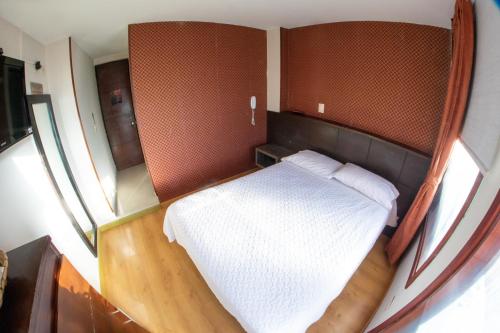 Un ou plusieurs lits dans un hébergement de l'établissement Hotel Plaza Muisca