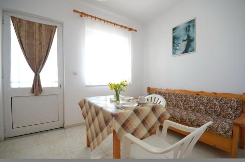 a dining room with a table and chairs and a window at Studio Anthoula in Kefalos