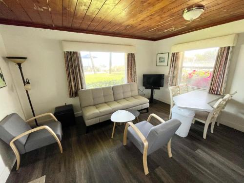 a living room with a couch and a table and chairs at Surf Studio Beach Resort in Cocoa Beach