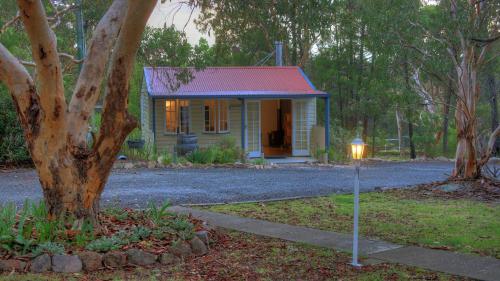a small house with a light next to a tree at 31 The Rocks in Stanthorpe
