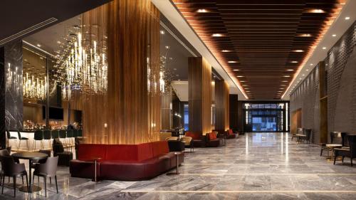 a lobby with a chandelier and tables and chairs at Grand Hyatt Nashville in Nashville