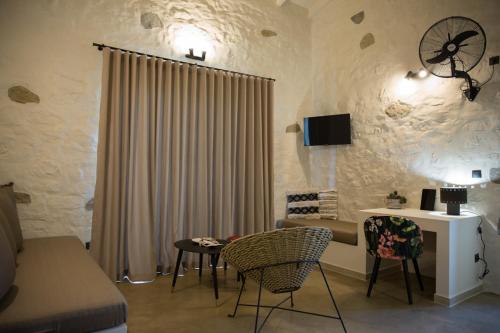 a living room with a couch and a table with chairs at Afentiko Pigadi in Methoni