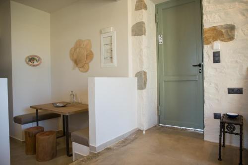 a room with a door and a table and a table at Afentiko Pigadi in Methoni