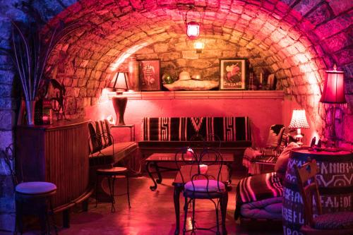 a room with a stone tunnel with chairs and a bed at Hotel Amor y Paz in Real de Catorce