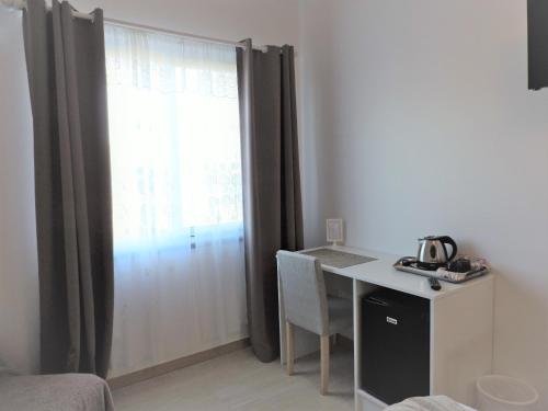 a room with a desk and a window with curtains at Vila Barca in Madalena
