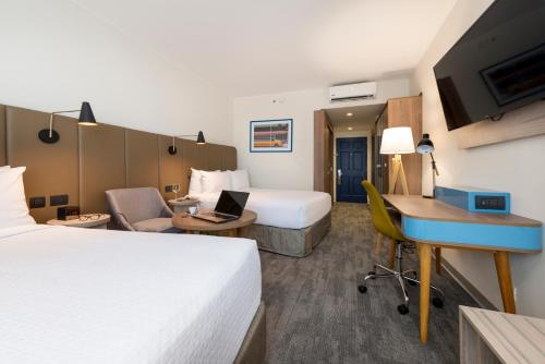 a hotel room with two beds and a desk at Crowne Plaza Lima by IHG in Lima