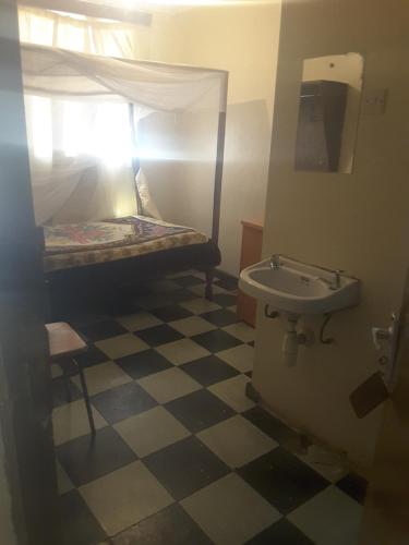 a bathroom with a bunk bed and a sink at DENOBASE MILIMANI in Nairobi