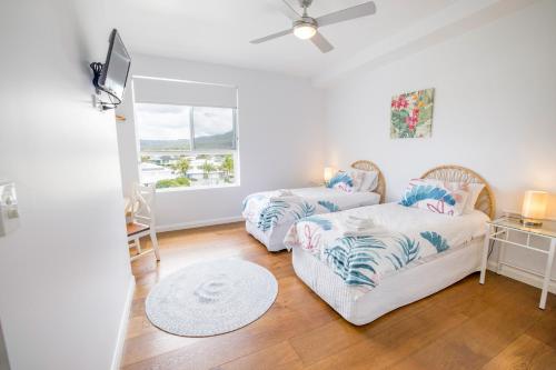 a living room with two couches and a window at Caba Break Holiday Apartments in Cabarita Beach