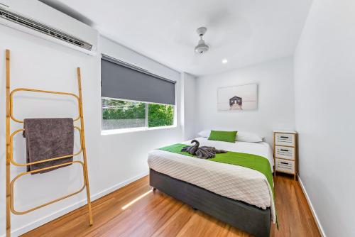 a bedroom with a bed and a window at BIG4 Whitsundays Tropical Eco Resort in Airlie Beach