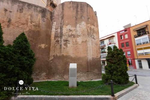 a large rock sitting in the middle of a city at Apartamento Roma, living suite en Vila real in Villareal