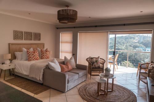 a bedroom with a bed and a couch at 516 Umdloti Resort in Umdloti