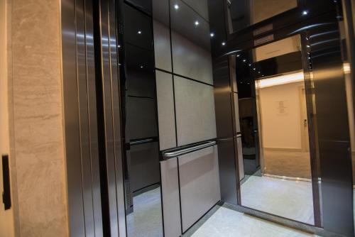 a walk in closet with a glass door at Dovv Hotel Busıness in Gaziemir