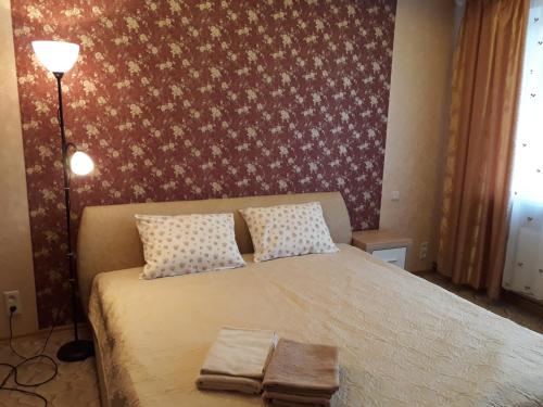a bedroom with a bed with two towels on it at Saulriets in Liepāja