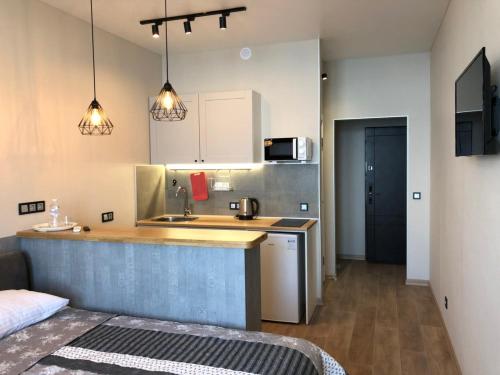 a kitchen with a sink and a counter top at Arcadia apartment & sea terrace in Odesa
