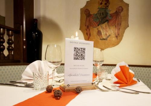 a table with a candle and wine glasses on it at Alpenhotel Ensmann in Göstling an der Ybbs
