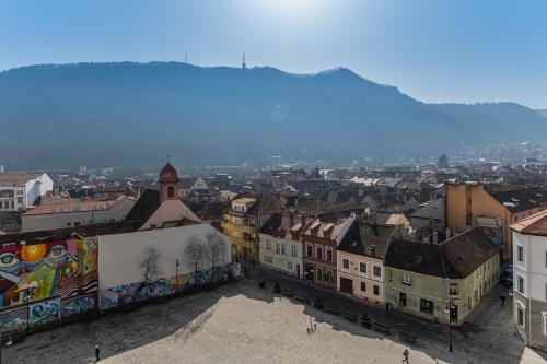 a view of a city with buildings and graffiti at Hotel Aro Palace in Braşov