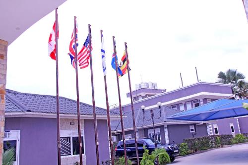 a group of flags in front of a building at Bethel Resort & Hotels in Gulu