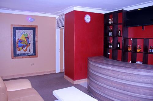 a bar in a room with a red wall at Bethel Resort & Hotels in Gulu