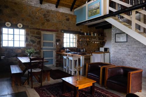 a living room with a couch and a table at Kliphuis in Van Reenen