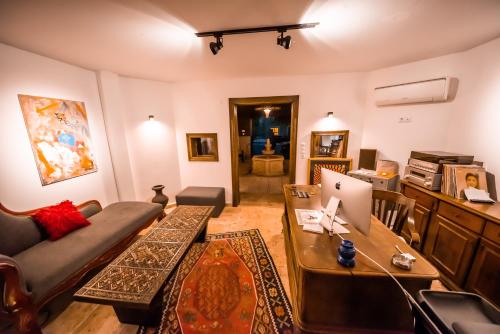 a living room with a couch and a table with a laptop at Murat Pasha Mansion in Dalyan