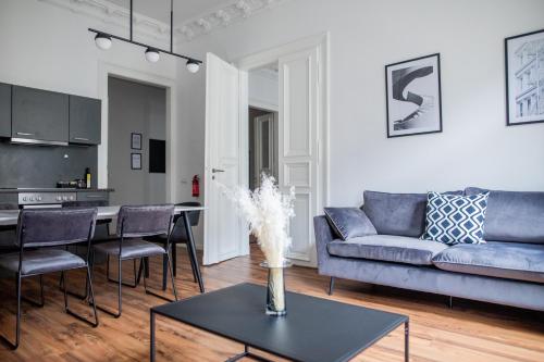 a living room with a couch and a table at Leipzig Residenz City-Center Apartments in Leipzig