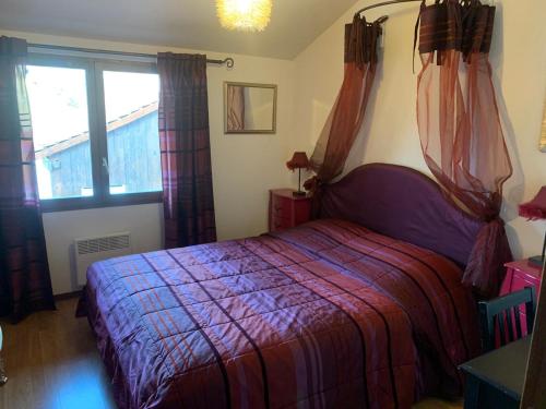 a bedroom with a bed and a window at Le Saint-Hilaire in Saint-Hilaire-de-Brens