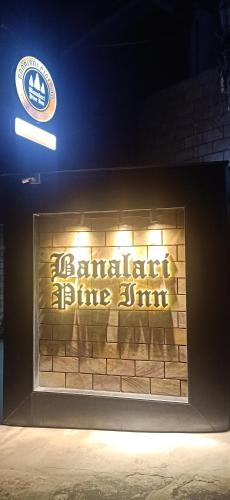 a brick wall with a sign on top of it at BANALARI PINE INN in Shillong