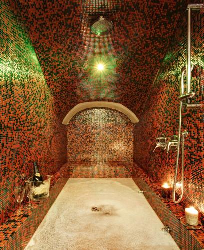 a bathroom with a large shower in a brick wall at Hotel Best Roma in Rome