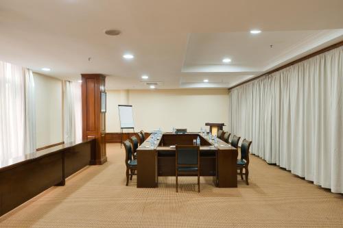 a conference room with a long table and chairs at Kibo Palace Hotel Arusha in Arusha