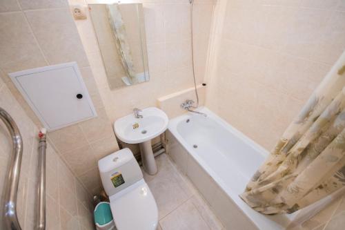 a bathroom with a sink and a toilet and a bath tub at Алтай 1-6, рядом с аэропортом in Almaty
