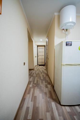 an empty hallway with a refrigerator in a room at Алтай 1-6, рядом с аэропортом in Almaty