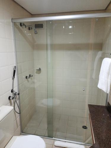 a shower with a glass door in a bathroom at Flat Space Valley - Para 2 Pessoas in São José dos Campos