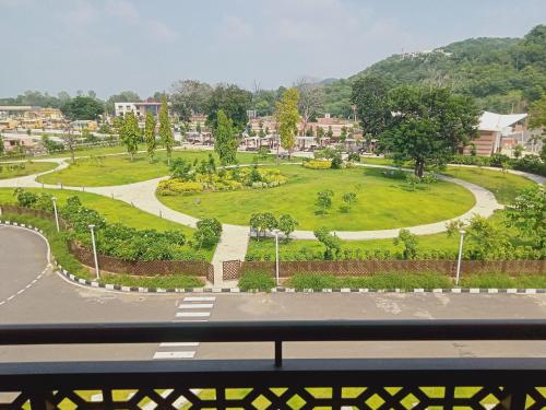 a view of a park in a city with a street at Ramada Encore by Wyndham Statue of Unity in Kevadia