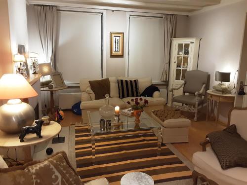 a living room with a couch and a table at Villa commune PoldersView in Sluis