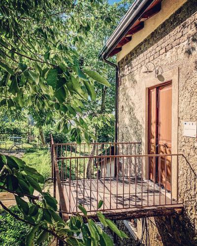 a dog sitting on a balcony of a building at Tenuta Novecento Bioagriturismo in Agerola