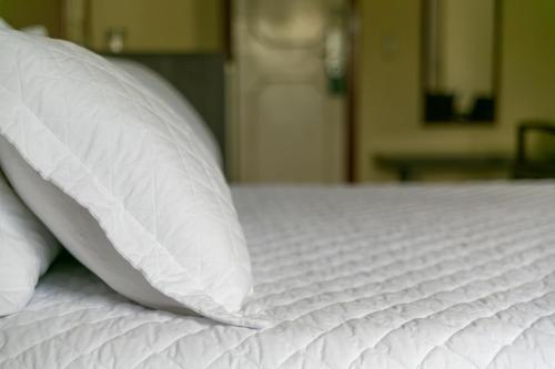 two white pillows sitting on top of a bed at Palácio Do Rio Hotel in Teresina