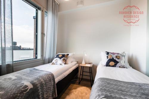Ένα ή περισσότερα κρεβάτια σε δωμάτιο στο Nordica Design Residence Rovaniemi