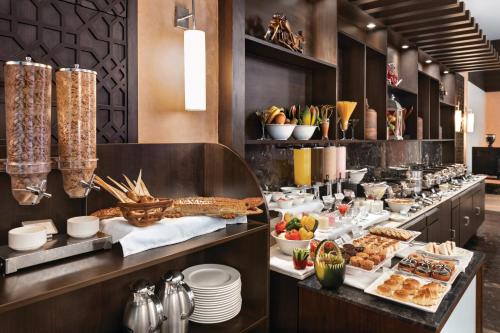 a buffet line with food in a hotel room at Ramada Encore by Wyndham Statue of Unity in Kevadia