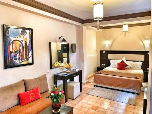 a bedroom with a bed and a couch in a room at Riad Al Madina in Essaouira